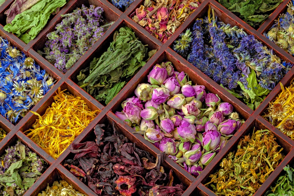 Assortment of dry herbs tea in wooden box.